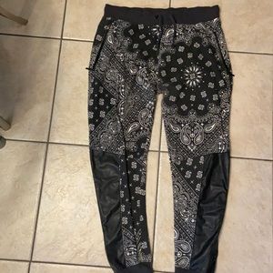 Joggers with leather details and zippers